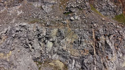 Aerial view of steep granite quarry walls and blue water Stock Footage 338222163