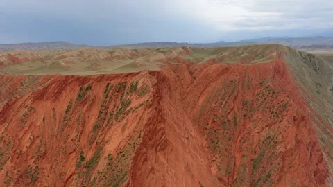 Aerial view of steep red eroded canyon cliffs in Xinjiang Stock Footage 345522346