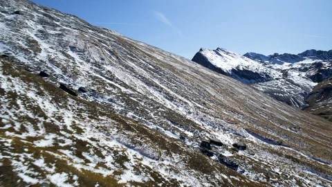 Aerial view of steep wild slopes of French mountains partly covered in snow. Stock Footage 127353985