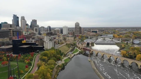 Aerial View of Stone Arch Bridge and Downtown with Fall Colors - Cloudy Day Stock Footage