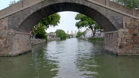 Aerial view of stone bridge and willow-lined canal in Wuxi Stock Footage 345102482