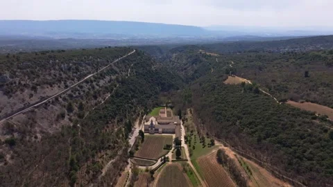 Aerial view of stone-built Senanque Abbey amid natural Provence landscape Stock Footage 313145828