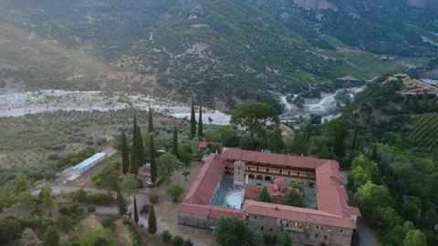 Aerial view of a stone Byzantine monastery castle and gorge river at sunset Stock Footage 343962575