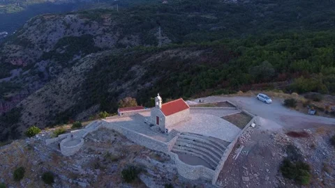 Aerial view of stone church complex on rocky mountain ridge Video stock 342765900