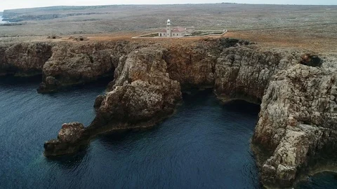 Aerial view of stone lighthouse on the edge of a cliff Stock Footage 116785290
