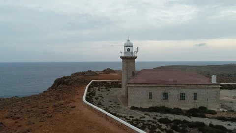 Aerial view of stone lighthouse on the edge of a cliff Stock Footage 116785291