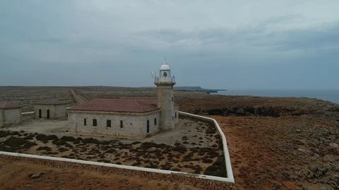 Aerial view of stone lighthouse on the edge of a cliff Stock Footage 116785695