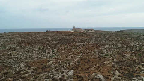Aerial view of stone lighthouse on the edge of a cliff Stock Footage 120297909
