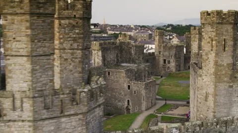 Aerial view of the stone medieval Caernarfon Castle in Wales Video stock 336756306