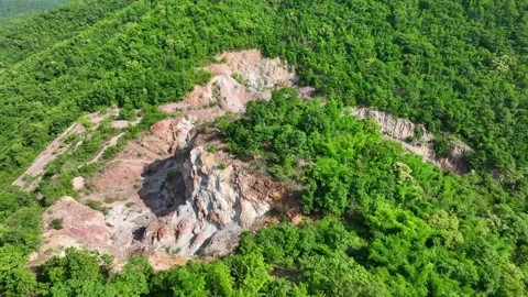 Aerial view of a stone quarry surrounded by forest. Видео 340564470
