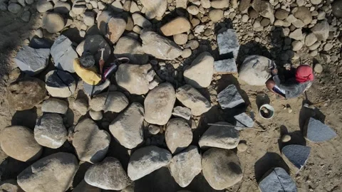 Aerial view of stone workers breaking boulders in Indonesia. Stock Footage 344998247