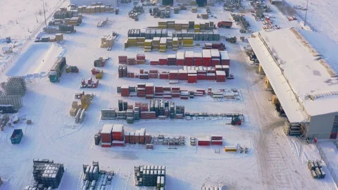 Aerial view of storage yard of building and structural materials on a winter day Stock Footage 100929167