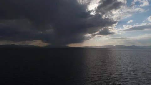 Aerial view of a storm cloud over Song-Kol lake, Kyrgyzstan Stockbeeldmateriaal 347240343