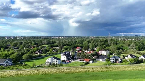 Aerial view of storm clouds gathering over residential houses and a bike path 動画素材 337036644