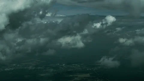 Aerial View of Storm Clouds Opening Over Landscape Below Stock Footage 337947742