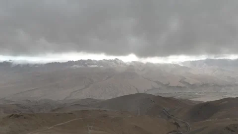 Aerial view of storm clouds over desert mountains in Xinjiang China Stock Footage 337674891