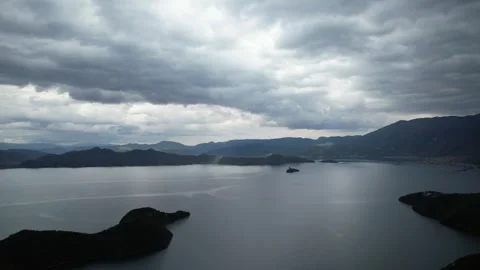 Aerial view of storm clouds over mountain lake and islands in China Stock Footage 337766406