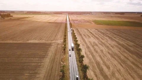 Aerial view of straight road in fields, flying over highway in summer Stock Footage 93904707