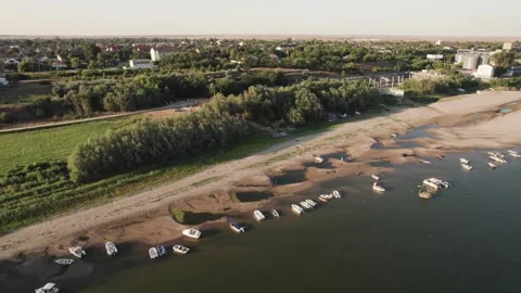 Aerial view of stranded boats on exposed Danube riverbank during low water Stock Footage 342751314