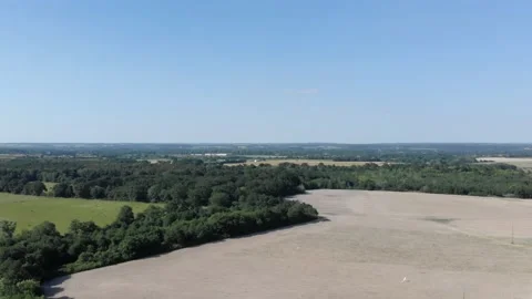 Aerial view of straw fields with bales and a tree in rural France at sunset Stock Footage 132048767