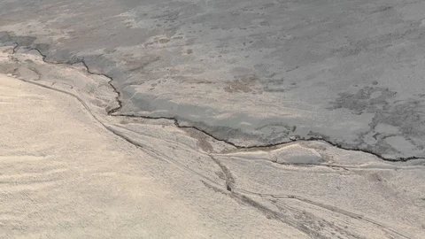 Aerial view of stream coming down mountain peak at sunrise, 4K Stock Footage 102337181