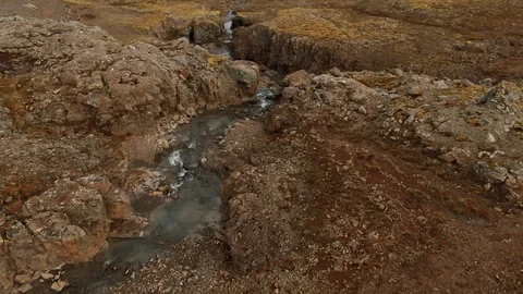 Aerial view of a stream of water running on volcanic soil in West Iceland Stock Footage 116184090