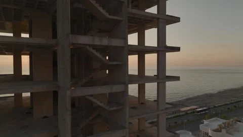 Aerial View: The structure of a luxury high-rise stands tall by the beach Stock Footage 296079137