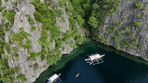 Aerial View of Stunning Limestone Cliffs and Boats on Crystal Clear Waters Stock Footage 295791734