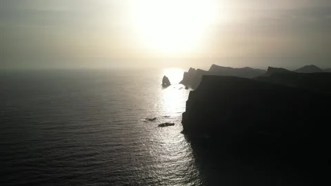 Aerial view of a stunning sunset casting a golden reflection on the calm oc.. Stock-Footage 327772762