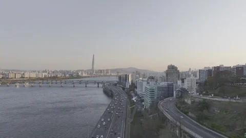 Aerial view of a stunning sunset over the Han River and Seoul skyline Stock Footage 332411797