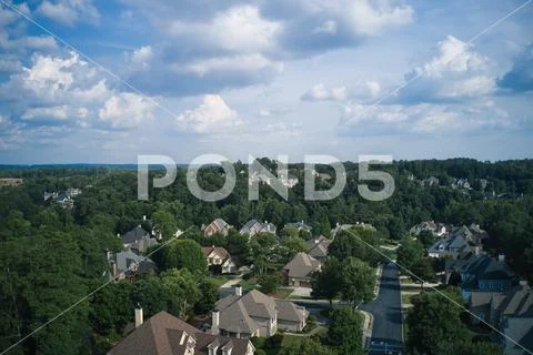 Aerial view of a sub division with beautiful landscape and houses