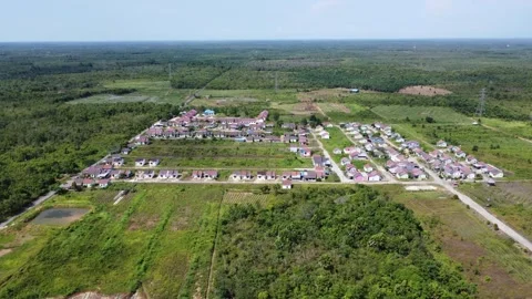 Aerial view of subsidized housing adjacent to oil palm plantations Stock Footage 265583358