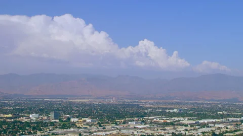Aerial view of suburb with mountains in background on a sunny day in Los Angeles Stock Footage 199458678