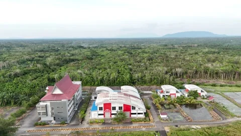 Aerial View of Suburban Building Complex and Green Landscapes in Tropical Region Stock Footage 329857100
