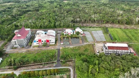Aerial View of Suburban Building Complex and Green Landscapes in Tropical Region Stock Footage 329857309