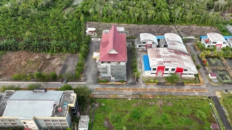 Aerial View of Suburban Building Complex and Green Landscapes in Tropical Region Stock Footage 329857466