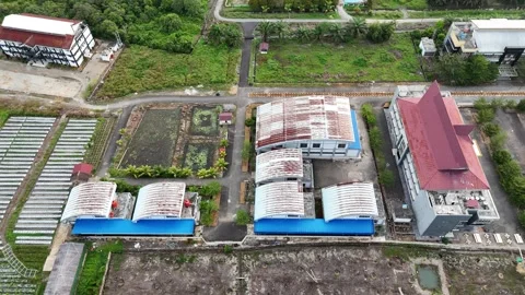 Aerial View of Suburban Building Complex and Green Landscapes in Tropical Region Stock Footage 329857704