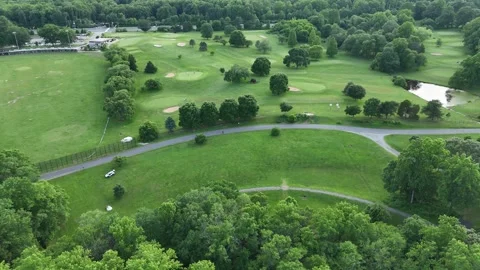 Aerial View of Suburban Golf Course with Fairways, Sand Traps, and Paved Trail Stock Footage 341989149
