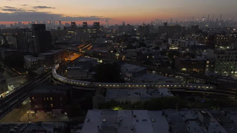 Aerial view of the subway passing through Brooklyn at night Stock Footage 252483908