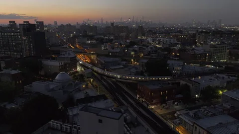 Aerial view of the subway passing through Brooklyn at night Stock Footage 252484446