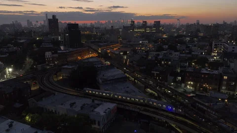 Aerial view of the subway passing through Brooklyn at night 스톡 동영상 252487586