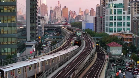 Aerial view of the subway passing through Queens at sunrise Stock Footage 254114816