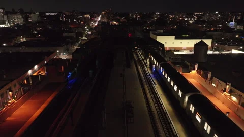 Aerial view of the subway passing through Brooklyn at night Stock Footage 287271395