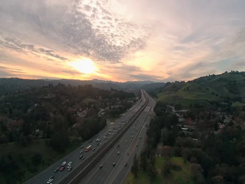 Aerial view of Sun Break over Freeway in California, Sunset - Cars - Traffic Video stock 85013573