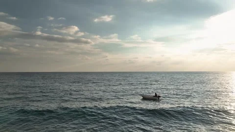Aerial View: The sun dips into the Mediterranean, creating a glowing horizon Video stock 296030451