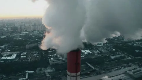 Aerial view of the sun getting obscured by polluting smoke from industrial stack Video stock 145399894
