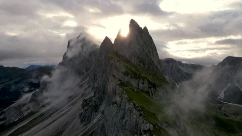 Aerial view of sun glowing between Seceda peaks Stock Footage 301244349