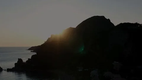Aerial view of the sun goes down the mountain in Glyfada beach, Greece Stock Footage 112247457