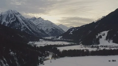 Aerial view of sun goes down behind the mountains of lechtal in alps Stock Footage 125163541