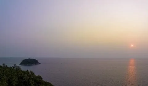 Aerial view the sun going down to the horizon in sweet sunset above coconut t Stock Photos